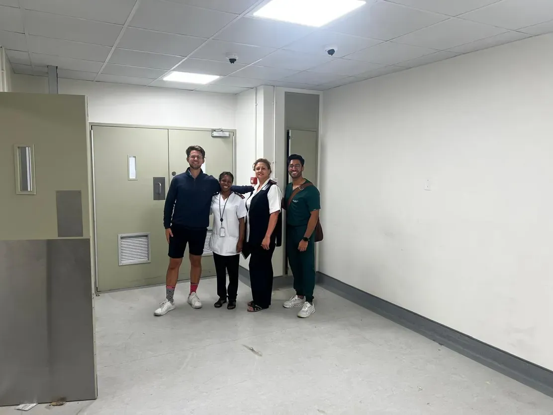 The Save7 team and Tygerberg staff standing in the empty room