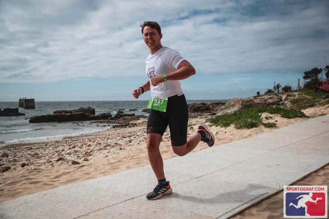 A Save7 athlete running along the beachfront during the Ironman 70.3